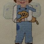 cross stitch boy angel in blue holding dog, charity quilt stitching, coles quilts