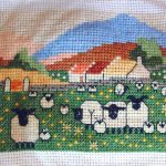 cross stitch pretty maids in a row with sheep, flowers and colorful hills