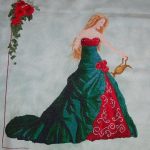 cross stitch queen of water with elegant lady long green dress, watering roses, model stitching.