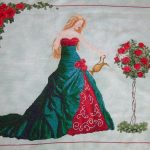 cross stitch queen of water with elegant lady long green dress, watering roses, model stitching.