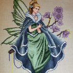 cross stitch twilight fairy, model stitching, lady green dress, blue cape, purple flowers, fantasy