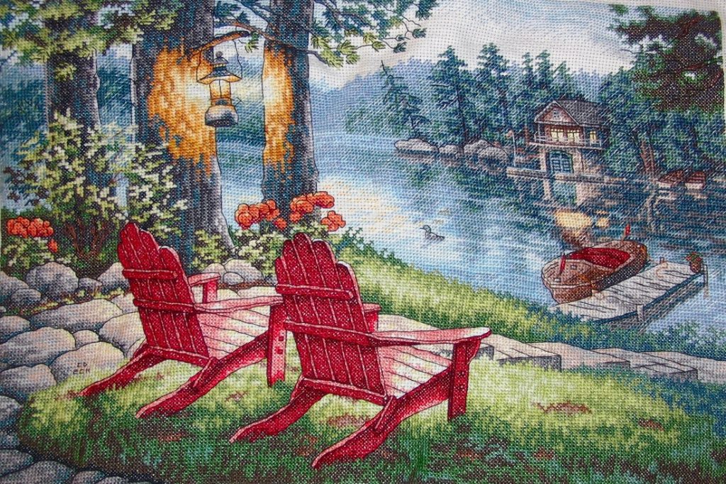 cross stitch twilights calm, peaceful outdoor scene, riverfront, chairs, boat, dock house, night