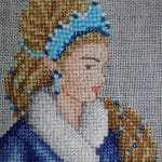 cross stitch winter fairy tale close up, model stitching, blue beads