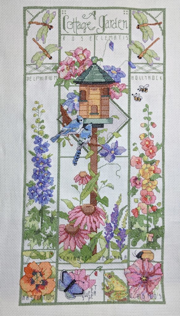 cross stitch a cottage garden, dragonfly, bird house, flowers, birds, scenery