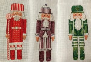 cross stitch nutcracker trio set, red, green purple set of three. Cross stitch & needlework magazine, model cross stitch