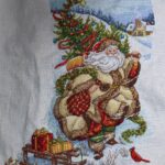 cross stitch santa's journey stocking by dimensions gold. Santa in gold carrying tree, sled, cardinals, winter