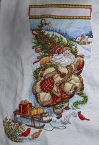 cross stitch santa's journey stocking by dimensions gold. Santa in gold carrying tree, sled, cardinals, winter