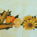 seasonal oranges cross stitch model stitching. orange and yellow flowers and food
