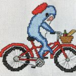 cross stitch cute shark on a bicycle. bike with basket