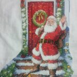 cross stitch welcome santa stocking. Santa waving at door step
